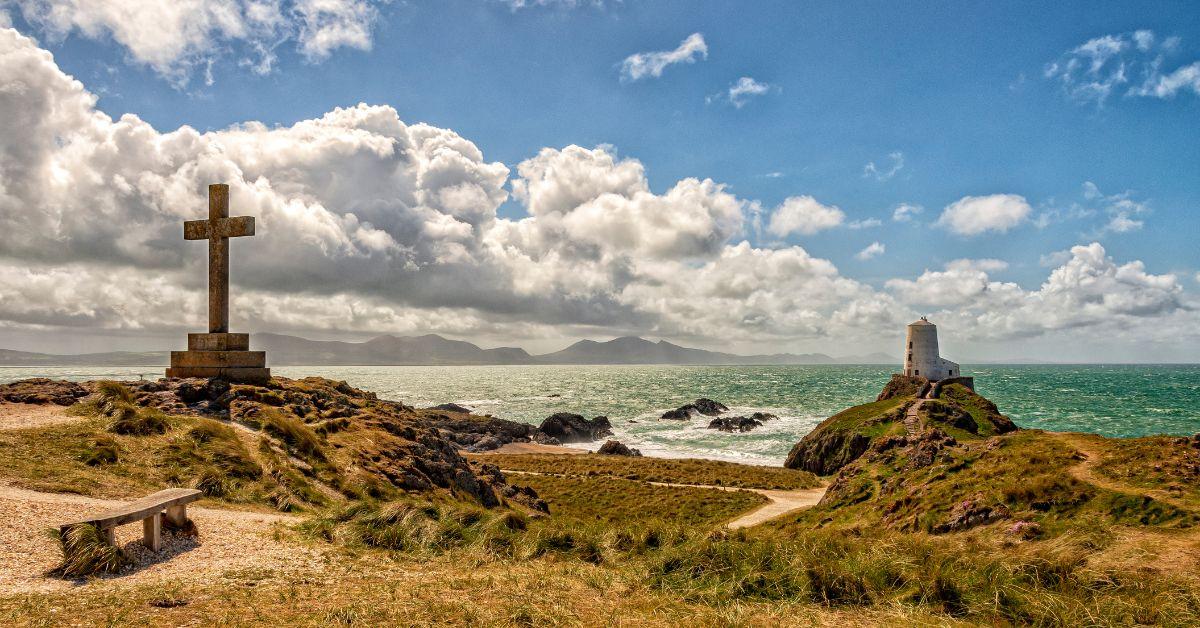 Llanddwyn Island with cross to commemorate the death of Santes Dwynwen.