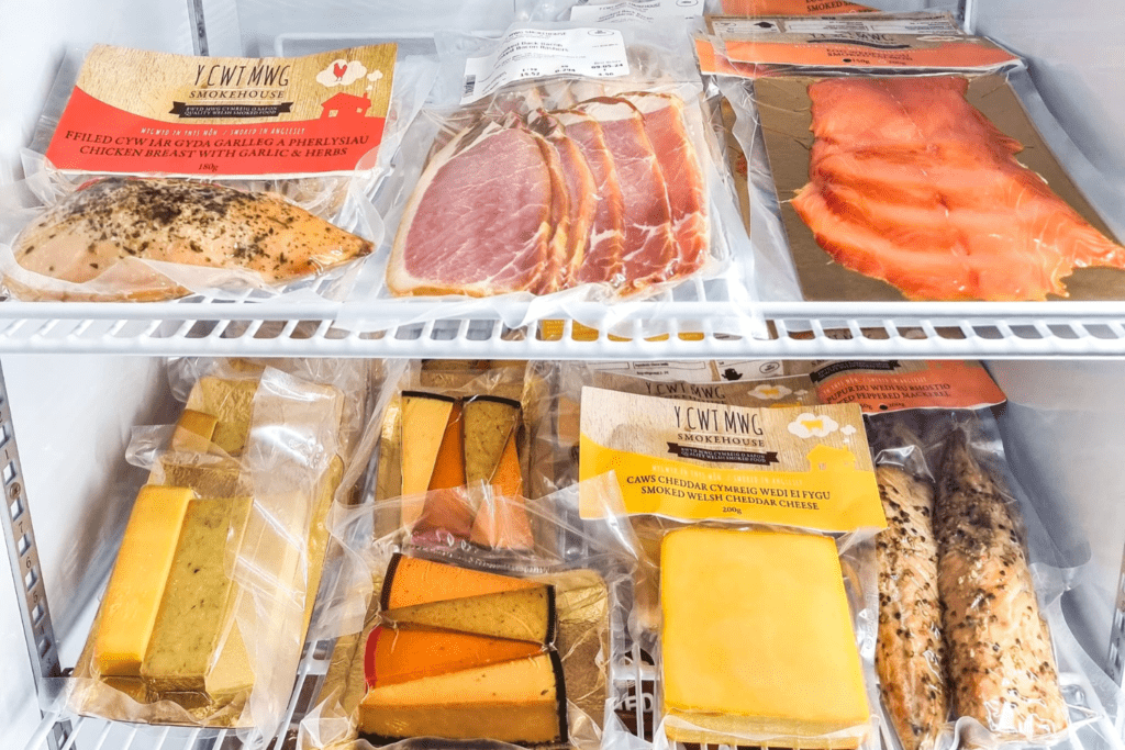 Y Cwt Mwg (Smokehouse) products; chicken, bacon, salmon, cheese platter, cheddar cheese, peppered mackerel.